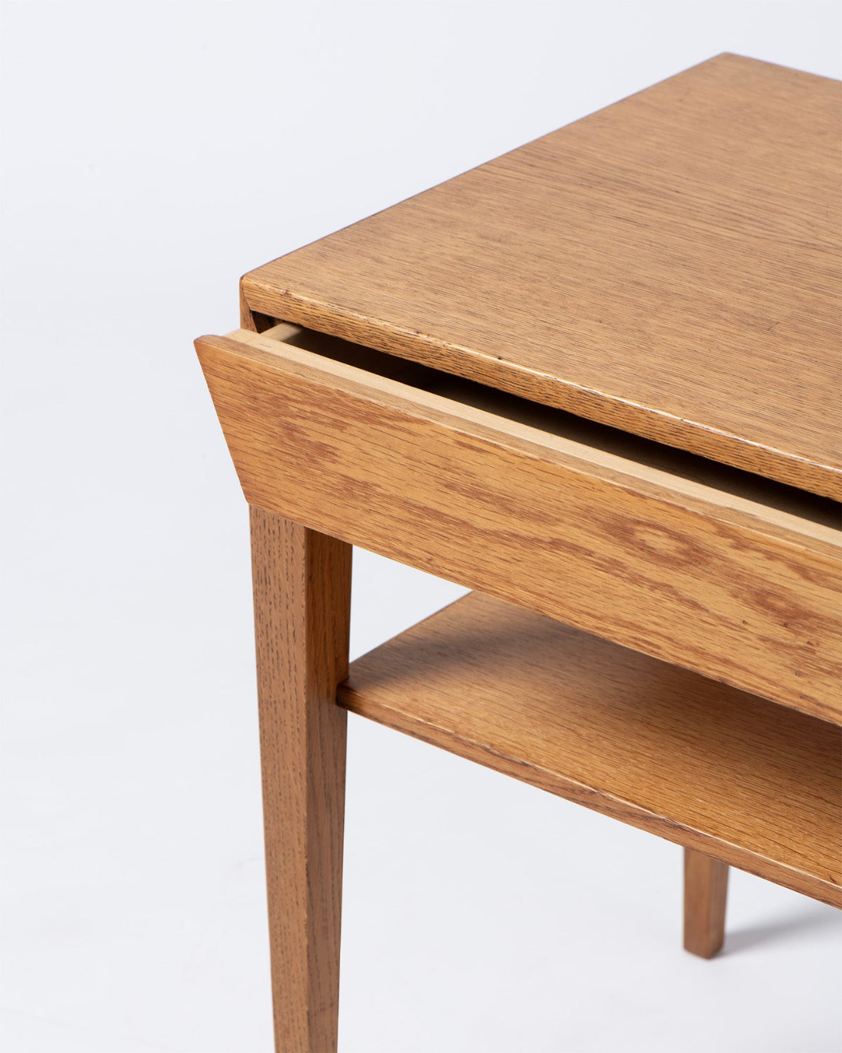 Wooden side table with a drawer on a white background