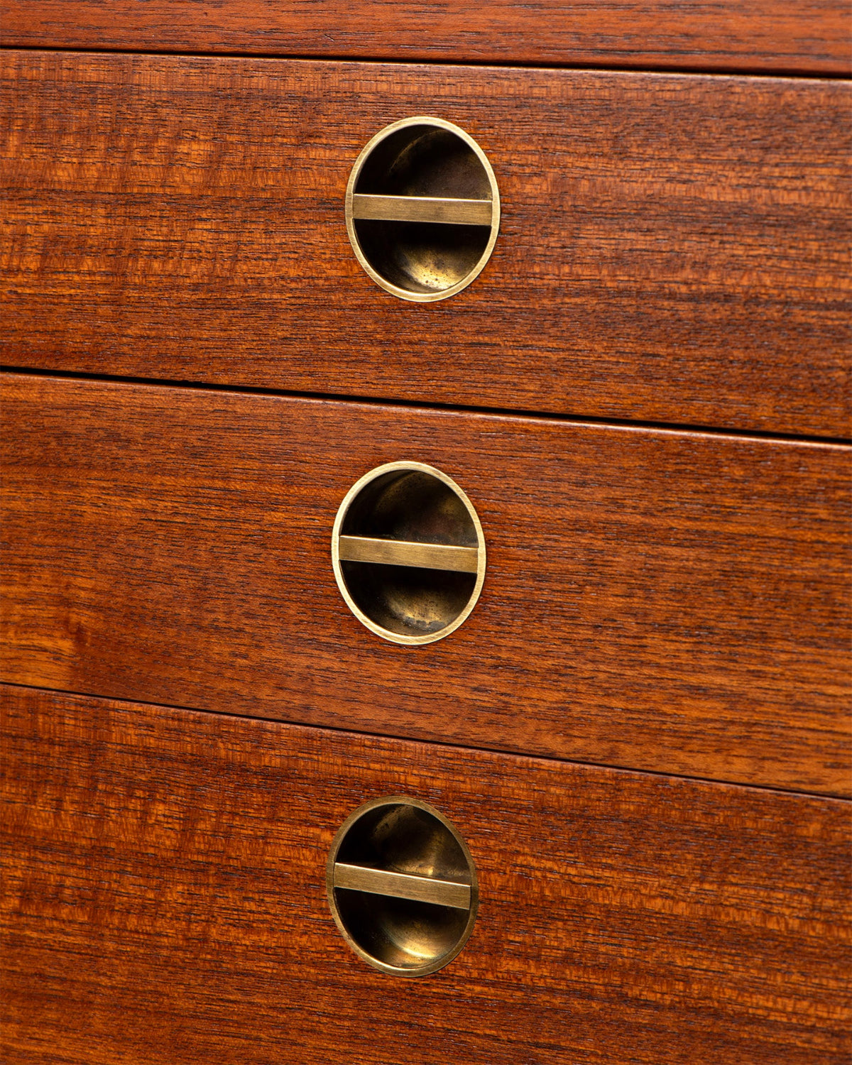 Close-up of wooden drawers with brass handles