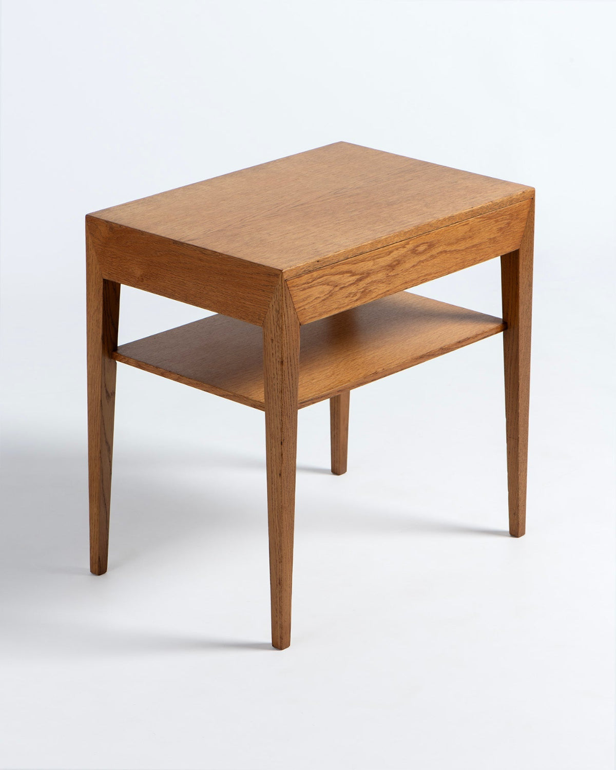 Wooden side table with a shelf on a white background